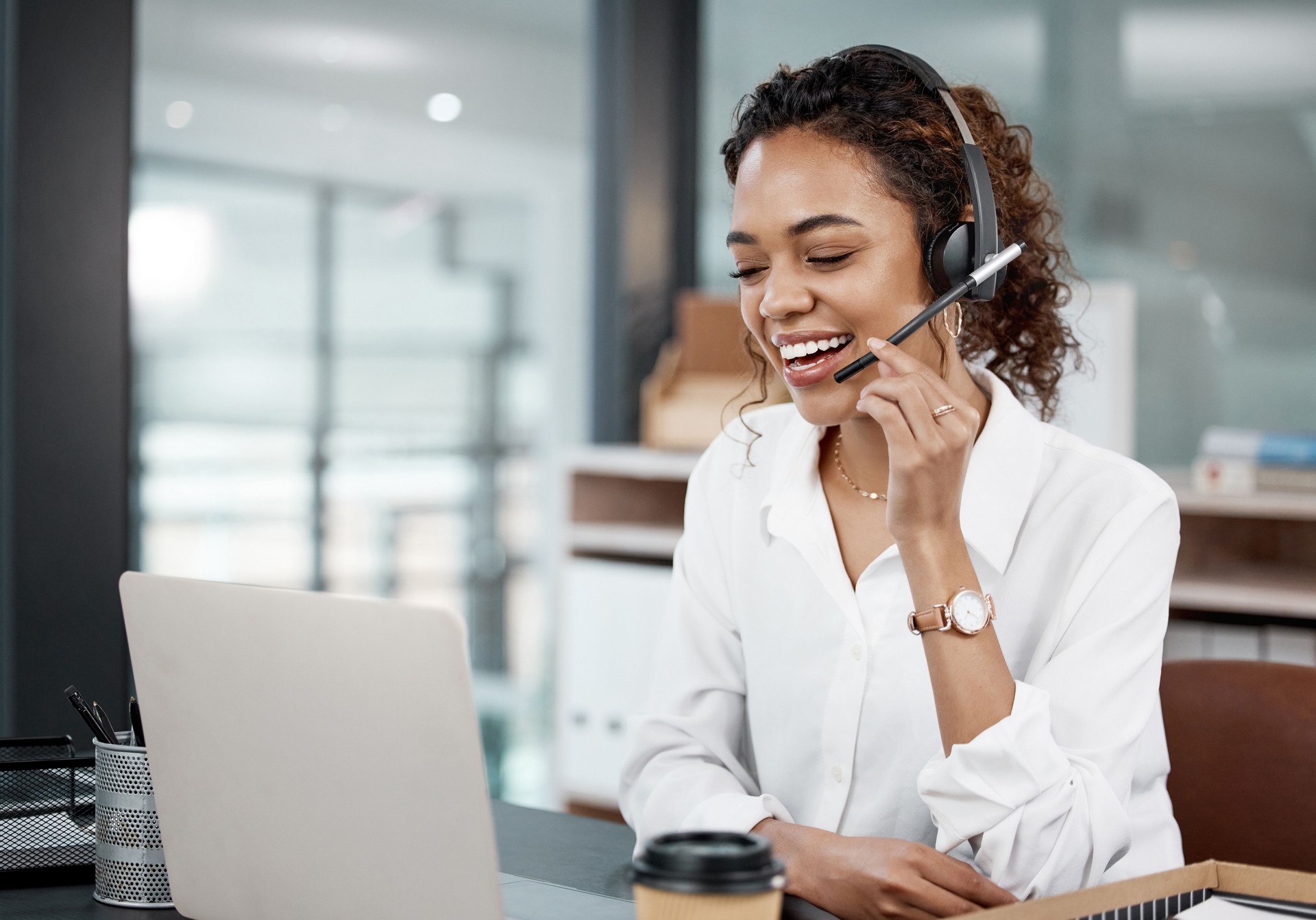 Cropped shot of an attractive young female call center agent working at her desk in the office